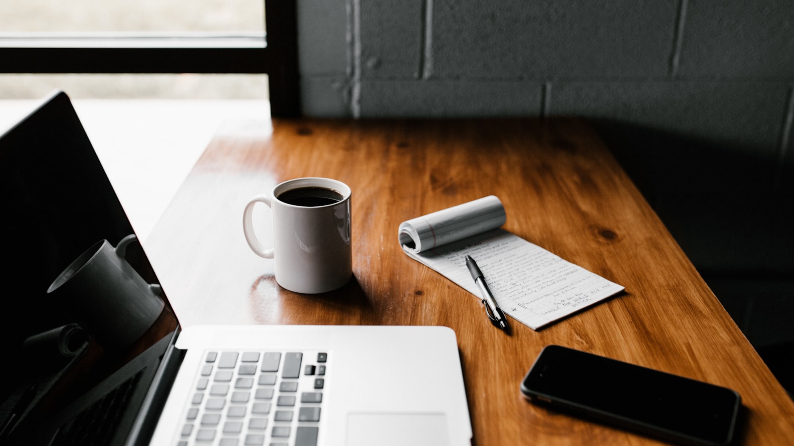 Laptop and coffee on a wooden table