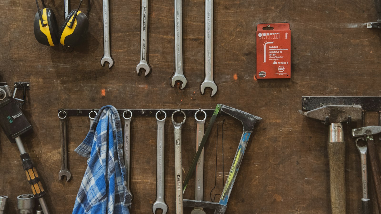 Wrenches and hand tools hanging on a workshop wall